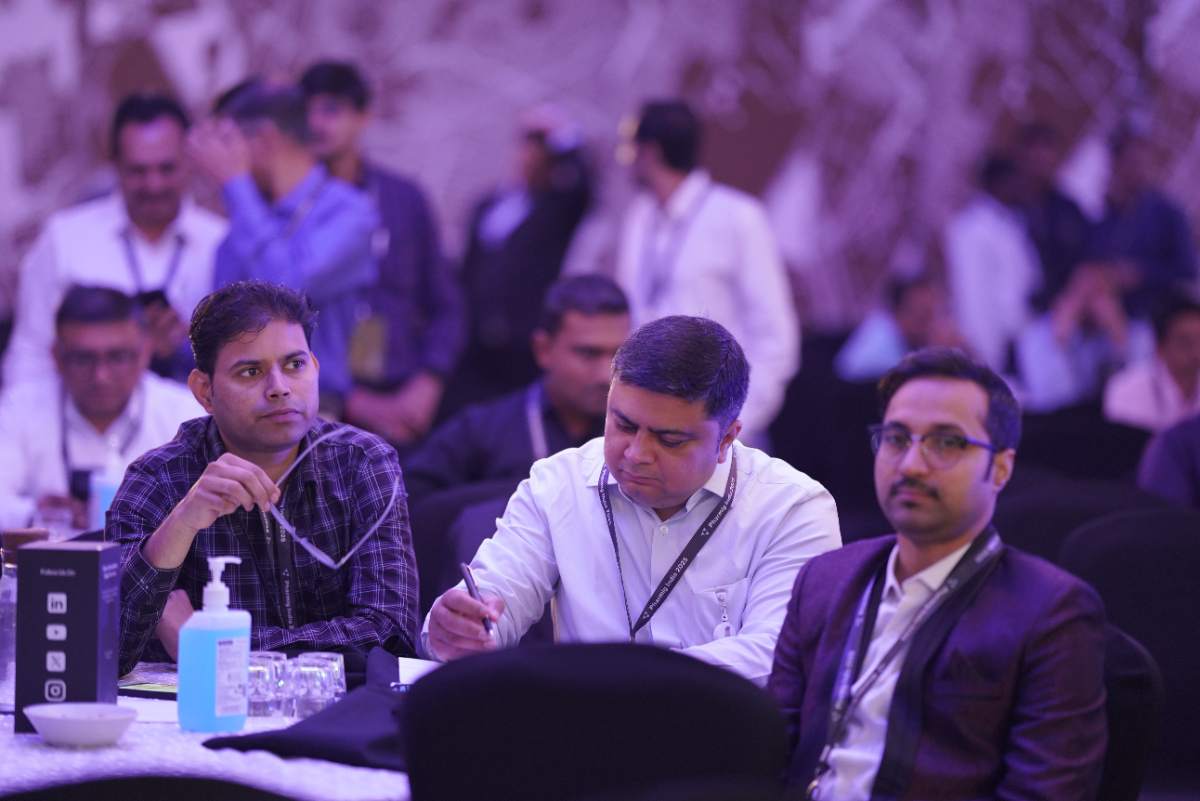 Delegates taking notes at their table during a Pharmig India 2025 session