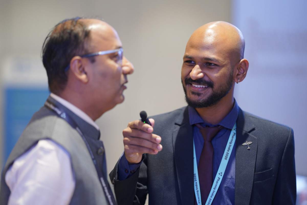 Two delegates in conversation while networking at Pharmig India 2025